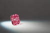 A closeup of a emerald cut argyle pink diamond