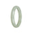 A close-up image of a white jade bangle bracelet with a half-moon shape. The bracelet is made of certified Type A white jade and has a diameter of 56mm. It is a creation by MAYS™.