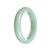 A light green Burma Jade bangle with a half-moon shape, untreated and genuine.