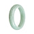 A light green Burmese jade bracelet with a half moon design, measuring 58mm.