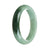 A half moon-shaped Burmese jade bangle with genuine Grade A green color and a darker green section.