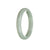 A delicate pale green jadeite bangle bracelet in a half moon shape, showcasing the natural beauty of this genuine Grade A gemstone.