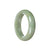 A close-up image of a beautiful, green jade bracelet with a half moon shape. The bracelet is made of genuine Type A jade and measures 53mm in diameter. It is a traditional and exquisite piece of jewelry from MAYS GEMS.