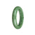 A close-up image of a round jade bangle with a half-moon shape, made from certified Grade A green jadeite jade. It has a diameter of 57mm and is crafted by MAYS™.