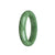 A half-moon shaped green jade bangle bracelet, certified as Type A, made by MAYS GEMS. The bracelet measures 57mm in diameter and features a traditional design.