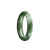 A close-up image of an olive green and white jadeite bangle with a half moon shape, measuring 53mm in diameter. The bangle appears to be of high quality and authentic grade A jadeite.
