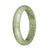 A pale green jade bangle with a half moon design, untreated and genuine, measuring 58mm in size. Sold by MAYS™.