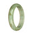 An elegant pale green Burmese jade bangle with a half moon design, certified Grade A quality.