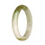 A close-up photo of a white and green patterned jade bangle, with a half-moon shape and a diameter of 57mm. The bangle is made of genuine grade A jadeite jade and is sold by the brand MAYS™.