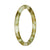 A close-up image of a petite round jade bangle with natural brown and pale green patterns.