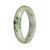 An elegant traditional jade bangle bracelet featuring a stunning combination of grey, green, and lavender colors. This certified untreated piece showcases a half moon design, measuring 57mm in size. Perfect for adding a touch of sophistication to any outfit.