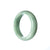 A close-up image of a delicate green jade bracelet crafted in the shape of a half moon, designed specifically for children. The bracelet features an authentic and natural green jade stone, giving it a unique and beautiful appearance. The item is from the MAYS™ brand.
