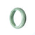 A small, half moon-shaped jade bangle designed for children, made from genuine Type A green traditional jade.