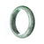 A half moon-shaped, 58mm untreated grey green jadeite bangle by MAYS™.