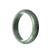 A pale green jade bangle bracelet with a traditional half-moon design, measuring 59mm in size.