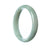 Image of an elegant, half-moon shaped pale green Burmese jade bracelet, measuring 57mm in size. Expertly crafted and authentically sourced, this exquisite piece from MAYS™ combines beauty and sophistication in a timeless design.