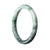 Close-up image of a round grey-green bangle bracelet made of genuine Grade A Burmese Jade, measuring 59mm in diameter. The bracelet is beautifully crafted with a smooth and polished surface, showcasing the natural beauty of the jade.